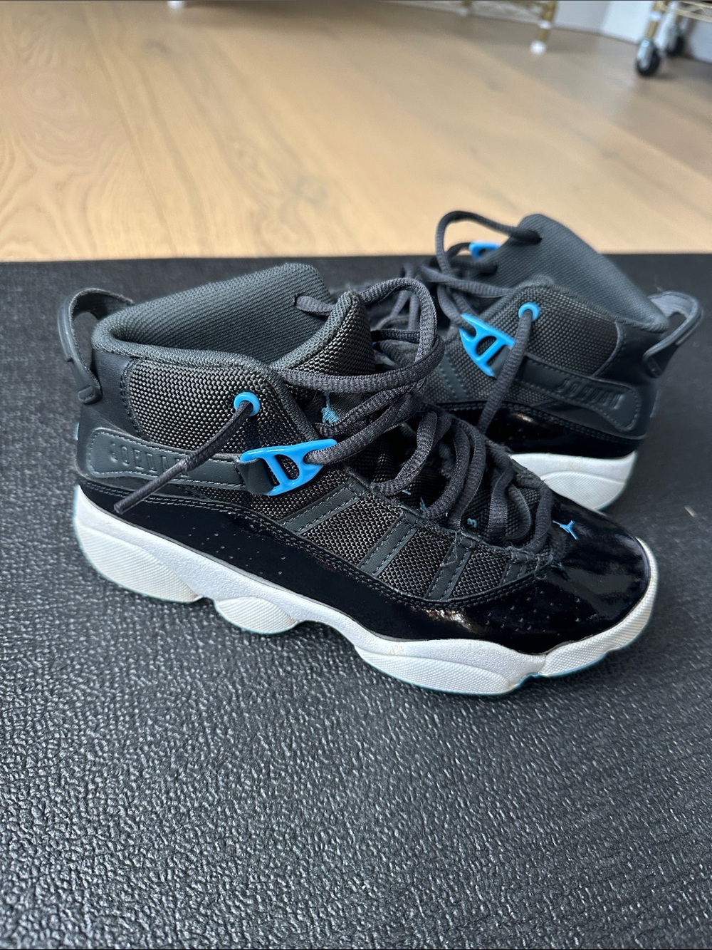 Kids Jordan’s Black and Blue High-Top Athletic Sneakers